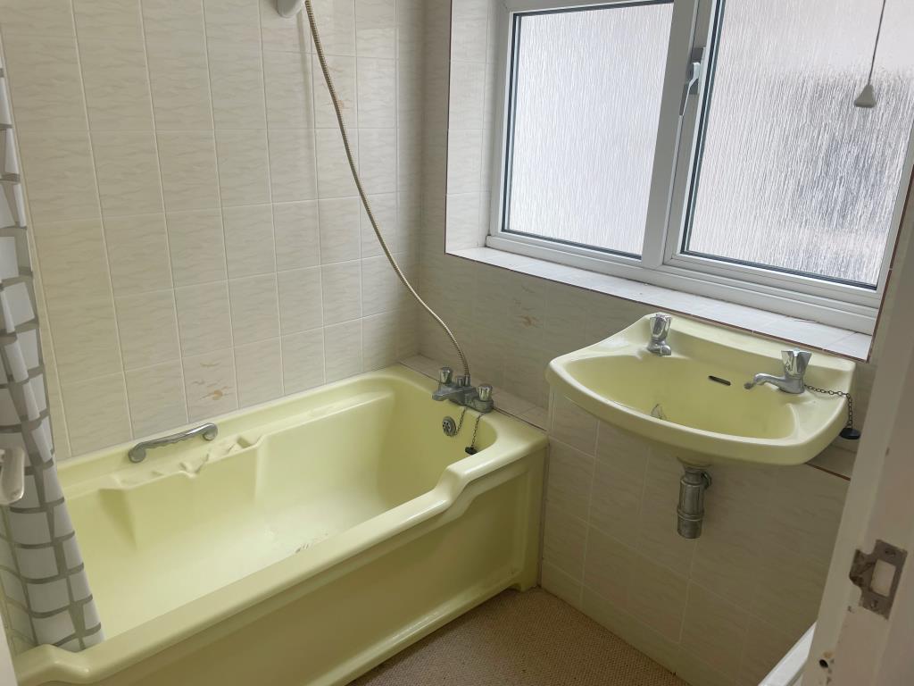 Lot: 156 - TWO-BEDROOM FLAT WITH SEA VIEWS - Bathroom sink and bath with shower